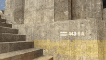stairs leading up to a concrete wall with the number 443-9a painted on it
