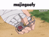 a hand with a bandage on it is holding a cage with the word majingoofy on the top