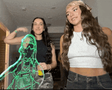 two women are standing next to each other and one has a drawing of a person that says toronto on it