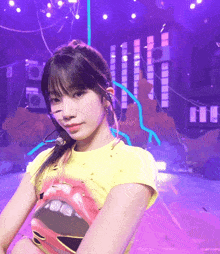 a girl wearing a yellow t-shirt with a mouth on it