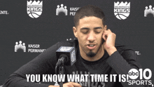 a man sitting in front of a microphone with the words " it 's winning time man " on the bottom