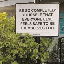 a sign on a pole that says be so completely yourself that everyone else feels safe to be themselves too