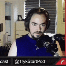 a man wearing headphones is sitting in front of a microphone ..