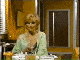a woman in a green robe is standing in front of a mirror with a yellow sign that says ux