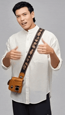 a man wearing a white shirt and a brown purse on his shoulder