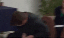 a man is kneeling down with cu and cb written on his head