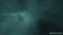 a dark blue background with a few clouds in the sky