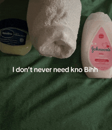 a bottle of johnson 's baby lotion sits next to a container of vaseline