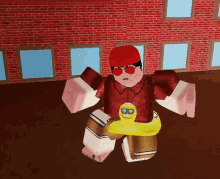 a man in a red hat and sunglasses is standing in front of a brick wall holding a yellow duck .