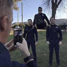 a man taking a picture of two police officers