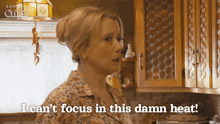 a woman says " i can 't focus in this damn heat " in a kitchen