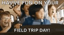 a group of people are riding on a school bus and laughing .