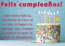 a birthday cake with candles and sprinkles and the words feliz cumpleanos on the bottom