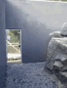 a gray wall with a door in it