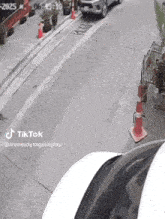 a car is parked on the side of a street with a tiktok watermark
