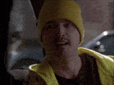 a person wearing a yellow beanie and a yellow vest
