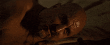 a close up of a person laying on a bed with a dirty face
