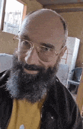 a bald man with a beard wearing glasses