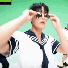 a young man wearing sunglasses and a sailor 's uniform with the word hone spire on the bottom