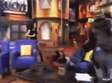 a blurry picture of people in a living room with the url rbd.gif on the bottom