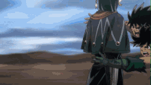 a man in a black cape is standing next to a boy in green gloves