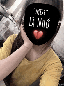 a girl covering her face with a mask that says " miss "