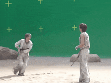 a couple of people standing in front of a green screen