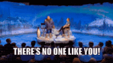 a group of people sitting in front of a stage with the words " there 's no one like you " on it