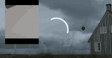 a red balloon is flying in the sky in front of a house