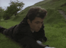 a man is laying on his stomach in the grass