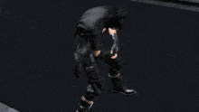 a man in a black jacket has a sticker on his sleeve that says ' nintendo '