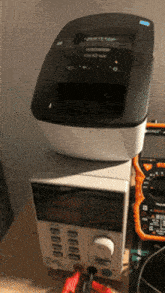 a printer sitting on top of a power supply