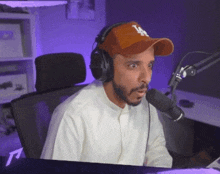 a man wearing headphones and a la hat