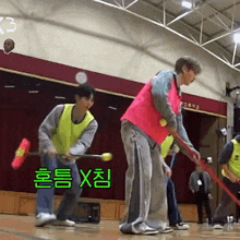a group of people are playing a game in a gym with chinese writing on the wall behind them