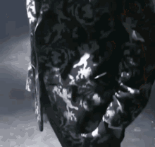 a close up of a person 's face with a black and white pattern on it .