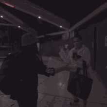 a blurry picture of two people holding hands in a dark room