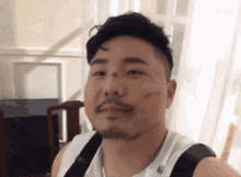 a man with a beard has a lipstick stain on his face