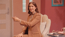 a woman is sitting in a chair with the word soma coming out of her hands