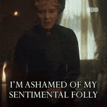 a woman says i 'm ashamed of my sentimental folly in front of a window