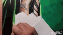 a hand is holding a piece of paper that says made in animatica on it