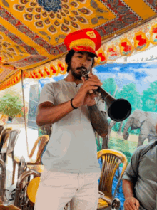 a man in a red hat is playing a trumpet