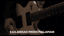 a man playing a guitar with the words kailangan mong malaman on the bottom right