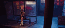a woman sits on a bench looking at her phone