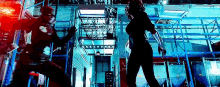 a man and a woman are fighting each other in a warehouse .