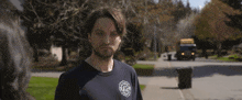 a man with a beard wearing a black t-shirt with the word fire on it