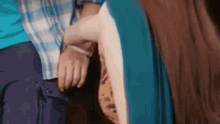 a man and a woman are holding hands in a close up .