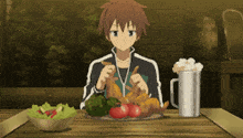 a boy is sitting at a table with a plate of food and a pitcher of beer