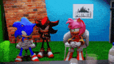 sonic the hedgehog shadow the hedgehog and amy the hedgehog sitting in front of a fortnite sign