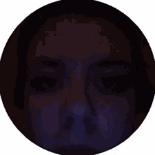a close up of a person 's face in a dark room