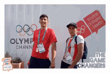 two young men are standing in front of a sign that says youth olympic games
